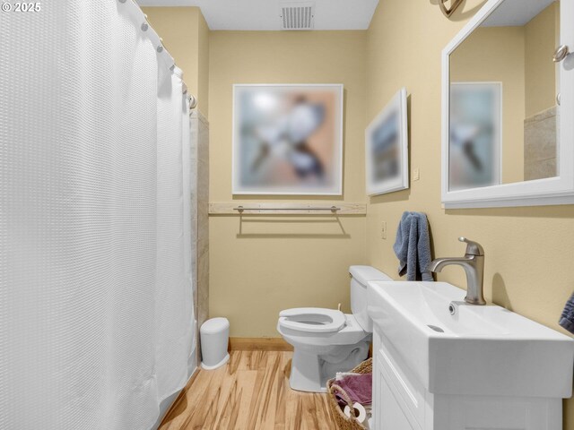 107 Sunset Blvd, Cannon Beach, OR 97110 - bathroom with toilet, vanity, wood finished floors, and a shower with curtain