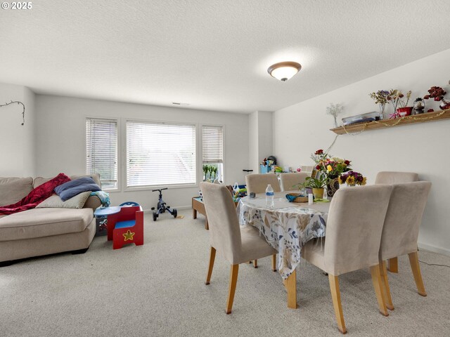 107 Sunset Blvd, Cannon Beach, OR 97110 - dining area featuring carpet flooring, a textured ceiling, and baseboards