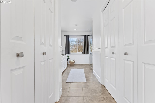 corridor with light tile patterned flooring