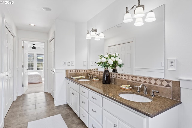 bathroom with tile patterned floors, vanity, and decorative backsplash