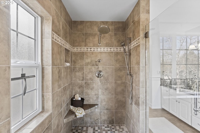 bathroom featuring vanity and tiled shower