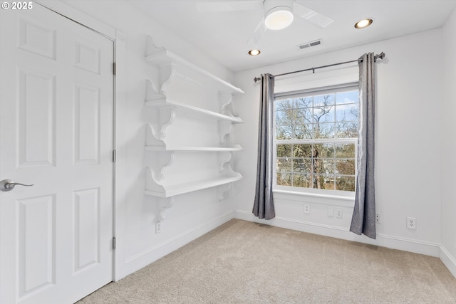 carpeted empty room with ceiling fan