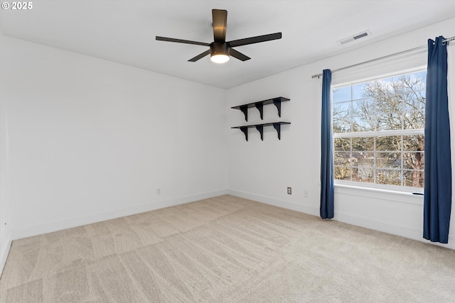 spare room featuring ceiling fan and light carpet