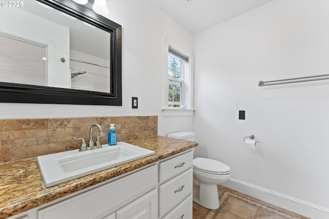 bathroom featuring tasteful backsplash, vanity, and toilet