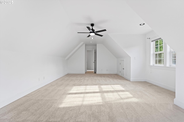 bonus room featuring lofted ceiling, light carpet, and ceiling fan