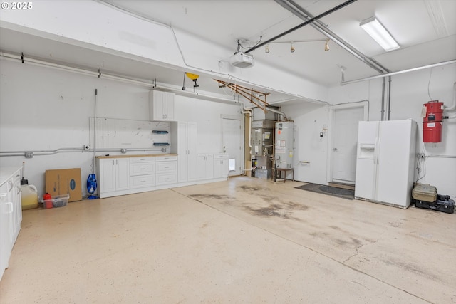 garage with gas water heater, a garage door opener, and white fridge with ice dispenser