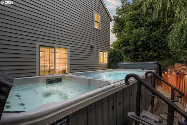 view of swimming pool with a hot tub