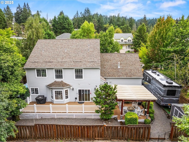 back of property featuring a deck