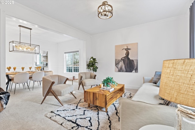 carpeted living room featuring crown molding and a notable chandelier