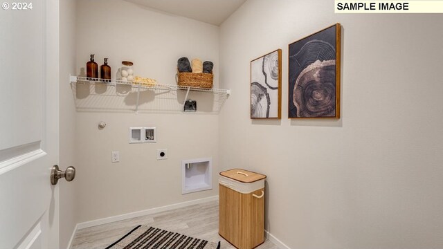 laundry area with hookup for a washing machine, hookup for an electric dryer, light hardwood / wood-style floors, and hookup for a gas dryer