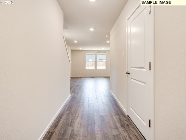 hallway with recessed lighting, dark wood finished floors, and baseboards
