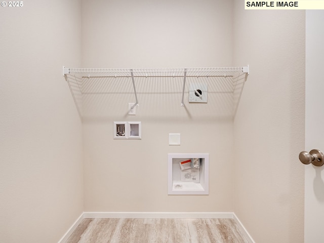 washroom featuring wood finished floors, baseboards, and hookup for a washing machine
