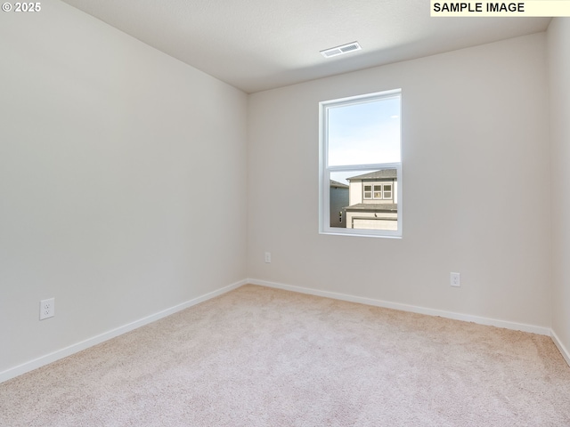 unfurnished room featuring carpet and baseboards