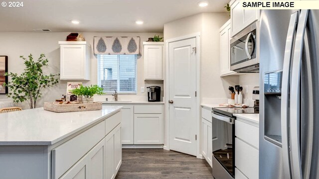 kitchen featuring white cabinetry, sink, dark wood-type flooring, and appliances with stainless steel finishes