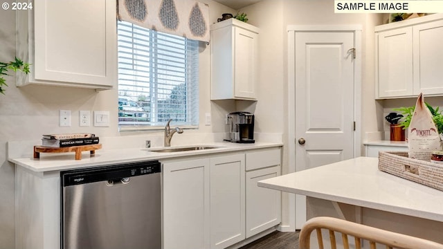 kitchen with dark wood-style floors, white cabinetry, a sink, light countertops, and dishwasher