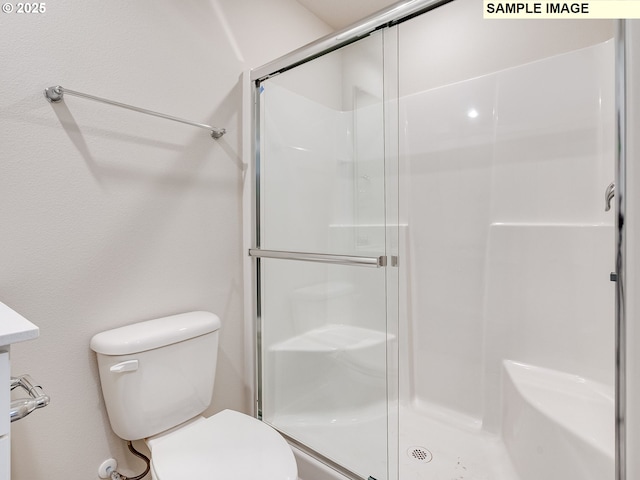 full bath with toilet and a shower stall