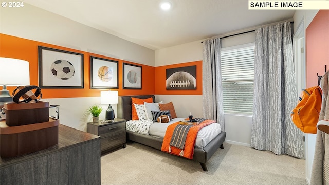 bedroom with baseboards and light carpet