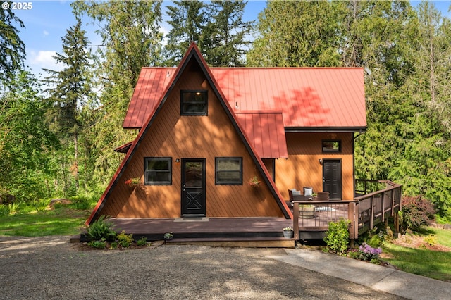 a-frame home with metal roof, a deck, and a standing seam roof