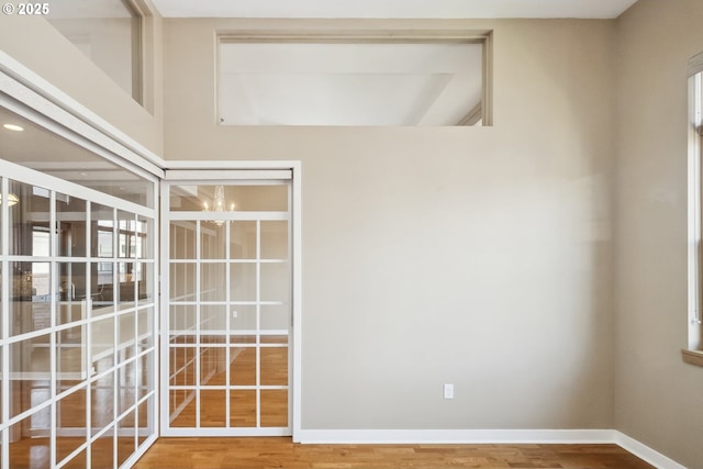 spare room with wood finished floors and baseboards