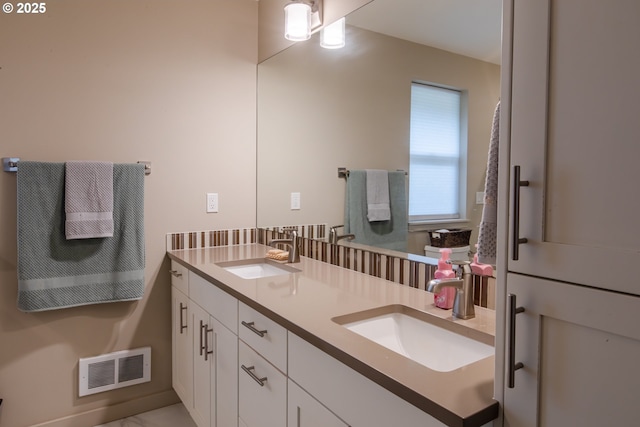 bathroom featuring a sink, visible vents, and double vanity