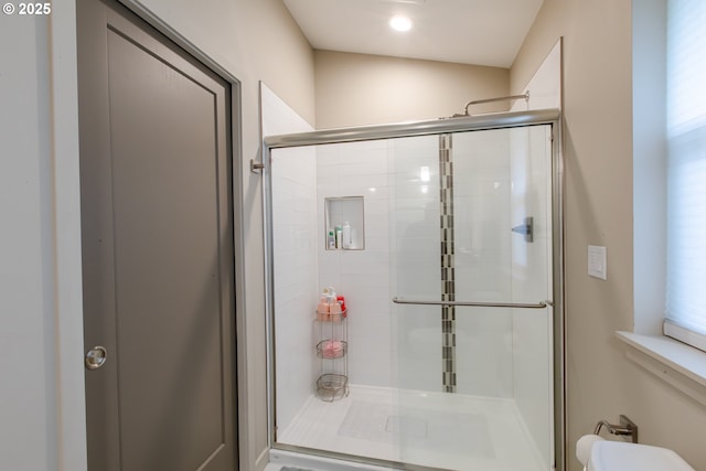 full bathroom featuring toilet and a stall shower