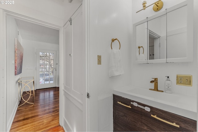 bathroom with hardwood / wood-style flooring and vanity