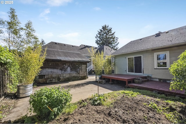 back of property featuring a deck and a patio area