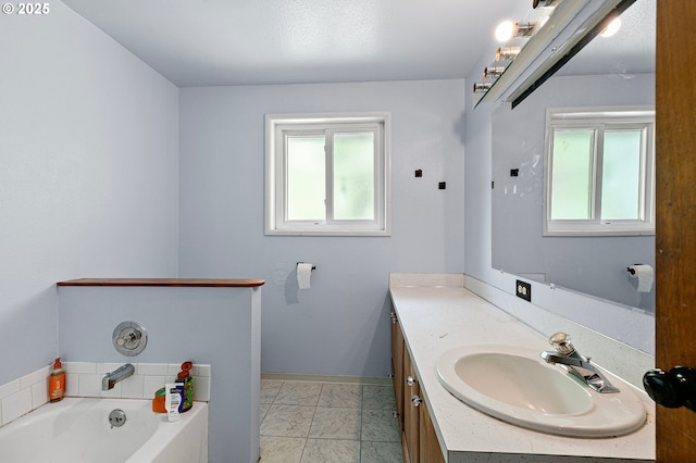 full bathroom with vanity, marble finish floors, a garden tub, and baseboards