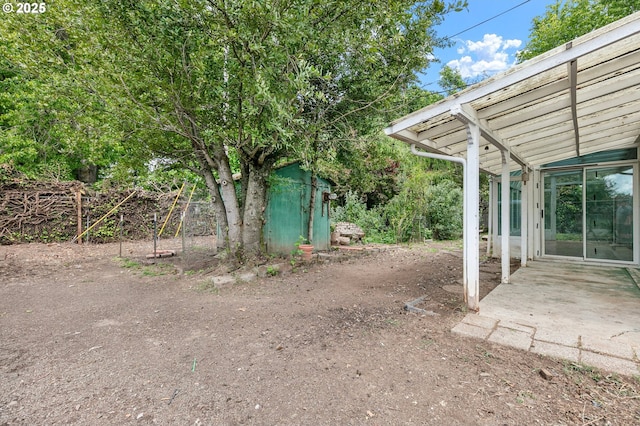 view of yard featuring a patio and an outdoor structure