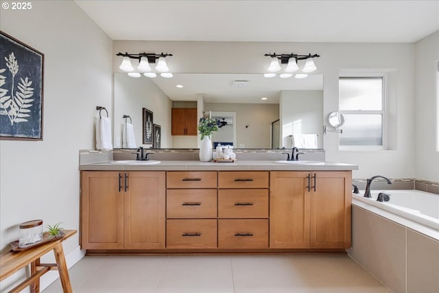 bathroom featuring tile patterned flooring, vanity, and a relaxing tiled tub