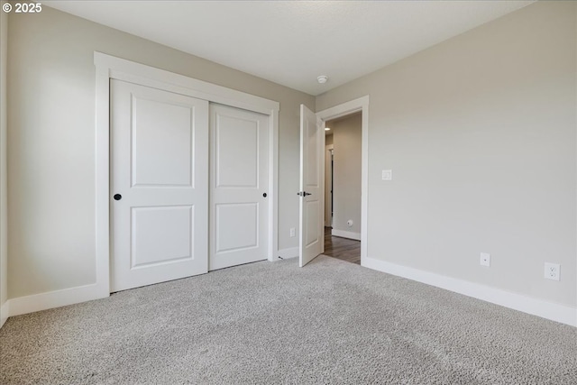 unfurnished bedroom with carpet floors and a closet