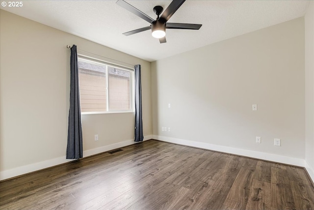 empty room with ceiling fan, wood-type flooring, and a textured ceiling