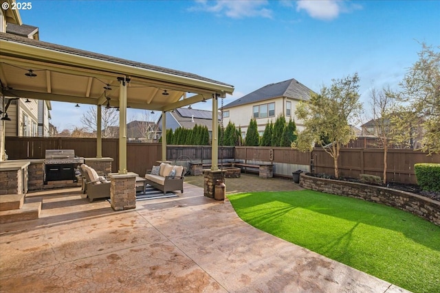 view of patio with a grill and an outdoor living space with a fire pit