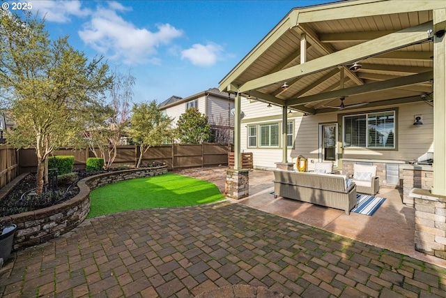 view of patio with an outdoor living space and ceiling fan