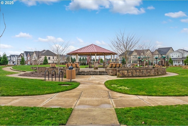 surrounding community with a gazebo and a yard