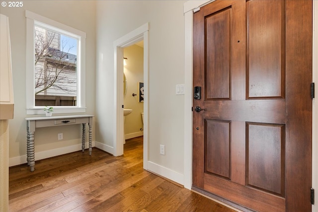 foyer entrance with light hardwood / wood-style floors