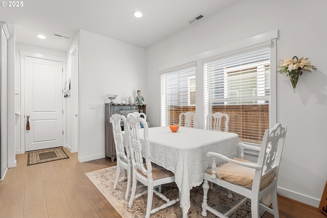 dining area featuring visible vents, baseboards, and light wood-style floors