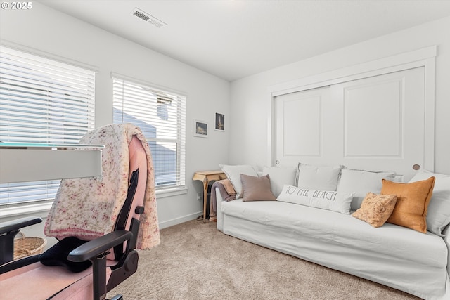 bedroom featuring a closet, baseboards, visible vents, and carpet floors