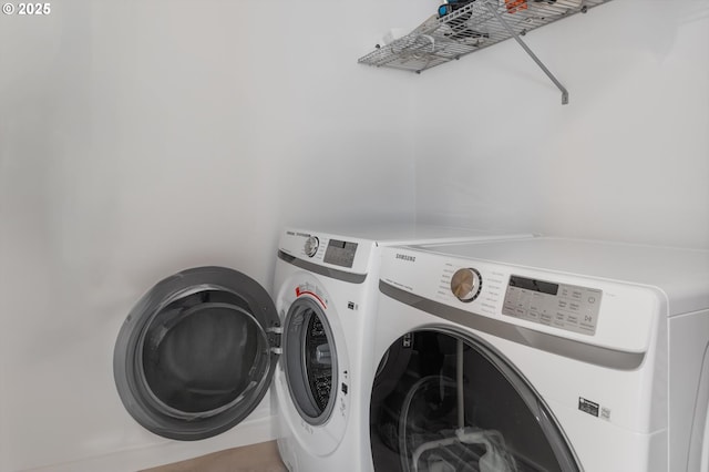 clothes washing area featuring laundry area and washing machine and dryer