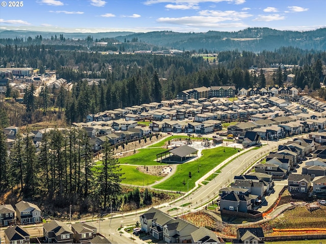 birds eye view of property with a forest view and a residential view