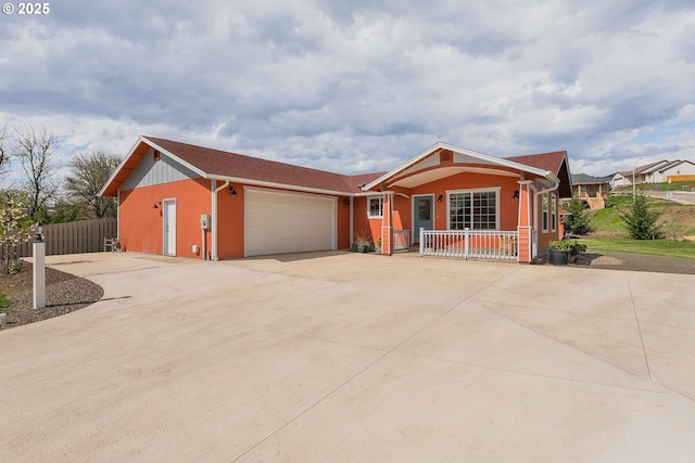 13130 Lookingglass Rd, Winston, OR 97496 - view of front of house featuring covered porch, concrete driveway, a garage, and fence