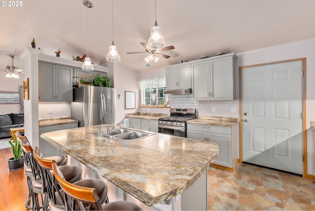 13130 Lookingglass Rd, Winston, OR 97496 - kitchen with a sink, stainless steel appliances, under cabinet range hood, and ceiling fan