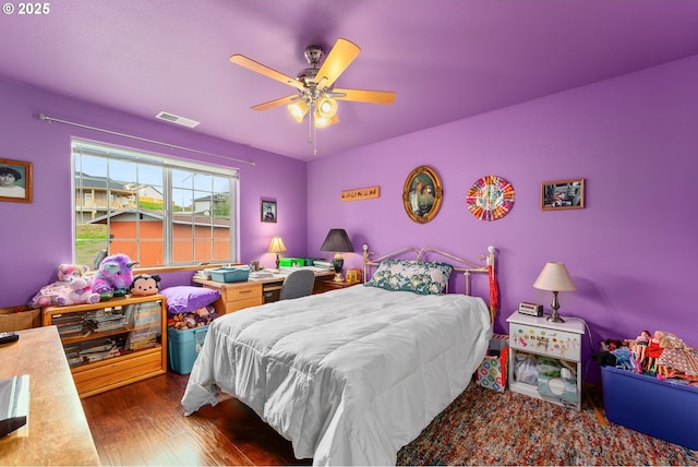 13130 Lookingglass Rd, Winston, OR 97496 - bedroom with visible vents, wood finished floors, and a ceiling fan