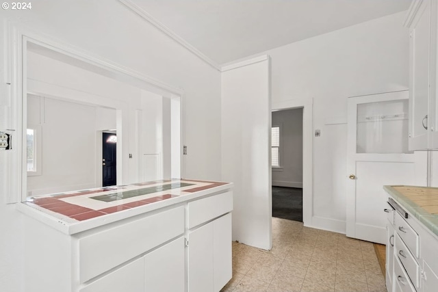 kitchen with white cabinetry and tile counters