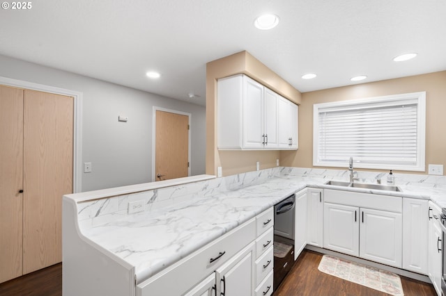 kitchen with dark hardwood / wood-style floors, dishwasher, white cabinetry, sink, and kitchen peninsula