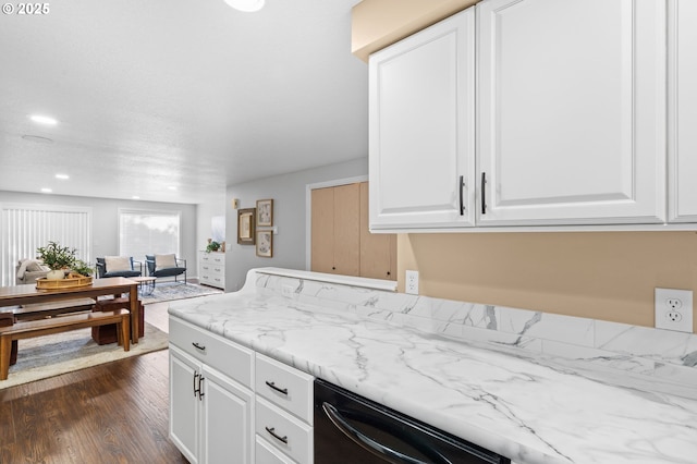 kitchen with white cabinetry, dark hardwood / wood-style flooring, light stone countertops, and dishwasher