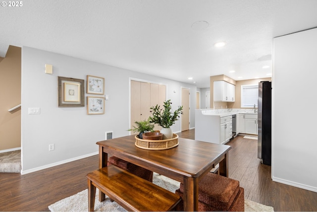 dining area with dark hardwood / wood-style flooring