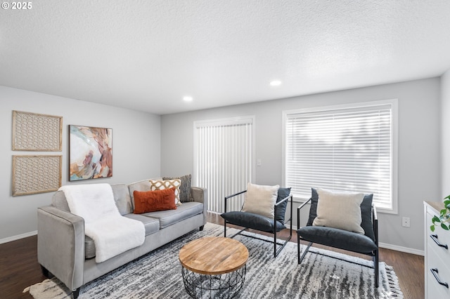 living room with dark wood-type flooring and a textured ceiling