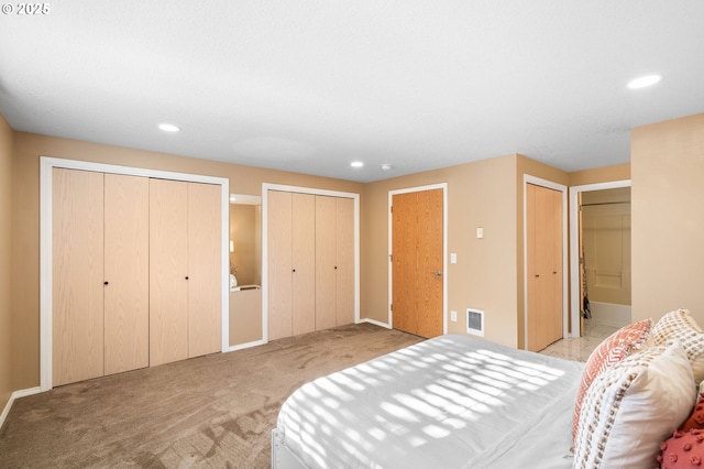 carpeted bedroom with multiple closets