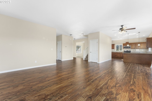381 SE Regan Hill Loop, Estacada, OR 97023 - unfurnished living room with dark wood-type flooring, a ceiling fan, and stairway